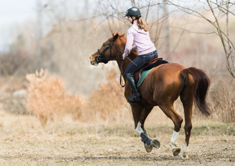 Young girl riding a horse