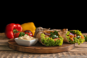 Delicious kebab sandwiches on wooden board