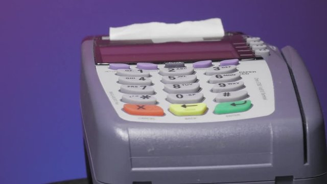 Credit card terminal rotating on a table.