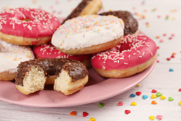 Tasty glazed donuts on color background