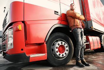 Handsome driver near big modern truck outdoors