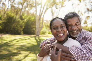 Fototapeta premium Outdoor Head And Shoulders Portrait Of Mature Couple In Park