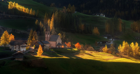 Italy. Dolomites. Autumn slopes of the church Santa Maddalena