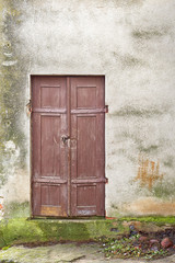 grunge wooden plank door, dirty stucco wall background