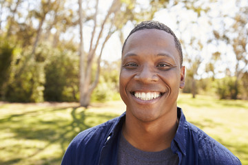 Outdoor Head And Shoulders Portrait Of Man In Park