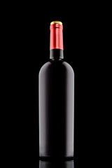 Red wine bottle at the black background