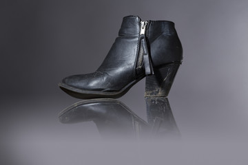 old, damaged female shoes with gray background