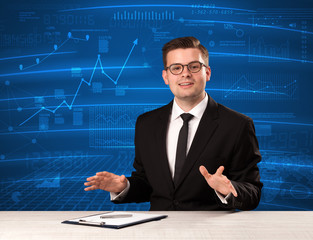 Stock data analyst in studio giving adivce on blue chart background