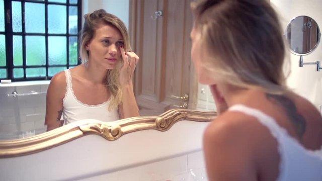 Woman applying undereye cream