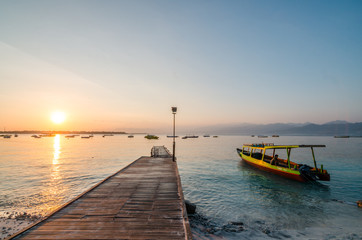 Fototapeta premium Beautiful sunrise at Gili Trawangan, or simply Gili T, is the largest of the three Gili Islands off Lombok. The island is one of the diving paradise in Indonesia.