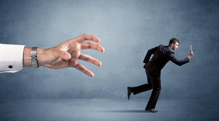 Businessman running from hand
