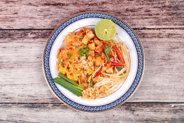 Popular Thai fried noodle call Pad Tai on Thai-pattern dish.