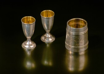 Three vintage glasses from silver, inside gilded. The background
