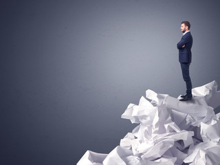 Businessman standing on crumpled paper