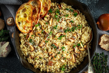Mushroom Risotto in iron pan with herbs and parmesan cheese