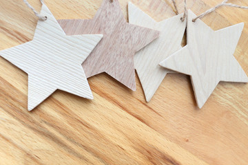 Wooden carved stars on wooden background.