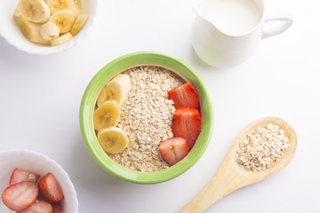 Bowl oats ingredients (oat, banana, strawberry and vegetal milk)