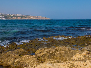 Fototapeta na wymiar Rethymno, Greece - July 31, 2016: Rocky Mediterranean beach.