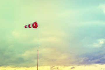 Horizontally flying windsock with blue sky in the background.