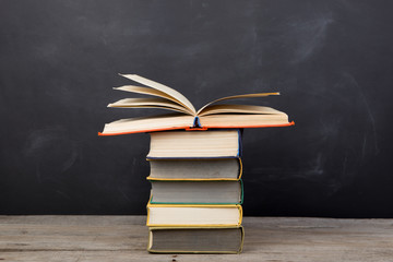 Education concept - books on the desk in the auditorium