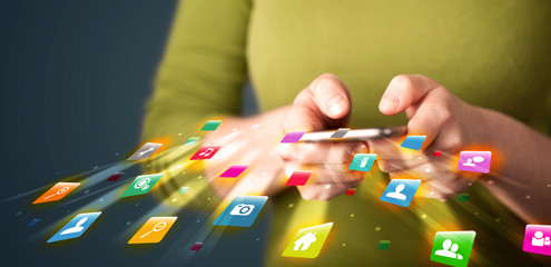 Man holding smartphone with technology application icons