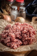 Minced meat on wooden background.