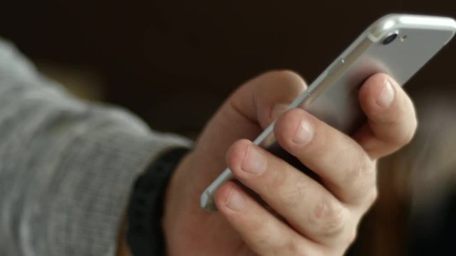 Men's Hand With Digital Clock Dials A Cell Phone Text