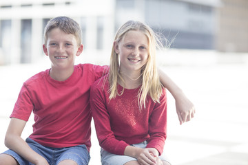 Best friends sitting together in the street