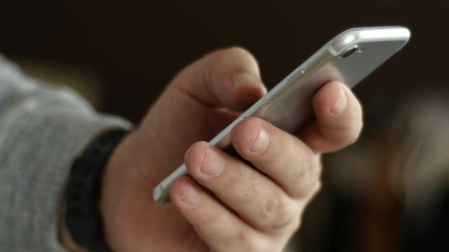 Men's Hand With Digital Clock Dials A Cell Phone Text