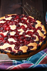 Homemade cherry pie on rustic background