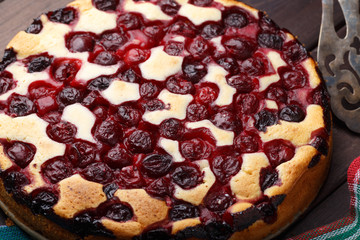 Homemade cherry pie on rustic background