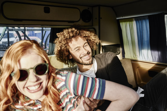 Happy young couple in a van