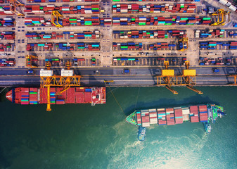 Fototapeta na wymiar container ship in import export and business logistic.By crane ,Trade Port , Shipping.cargo to harbor.Aerial view.Water transport.International.Shell Marine.Top view.