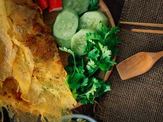 Vintage style Thai traditional food stuffed crispy egg crepe on top and wooden background wallpaper