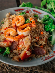 Vintage style Thai traditional food fried rice with shrimp on top and wooden background wallpaper