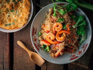 Vintage style Thai traditional food fried rice with shrimp on top and wooden background wallpaper