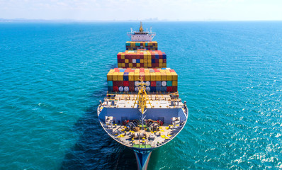 container ship in import export and business logistic.By crane ,Trade Port , Shipping.cargo to...