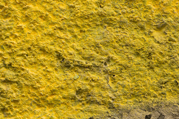 rough textured wall painted in yellow