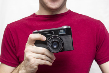 Fototapeta premium Man in a red shirt with old camera, white background