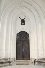 Obraz premium Old church doors with trophy below.