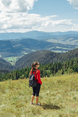 Woman and backpack in mountains