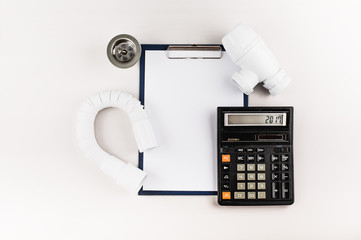 Folder with clip, calculator and plumbing supplies.