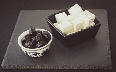 Pieces of cheese and olives