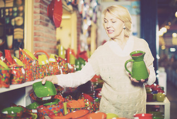 Woman buying ceramic tableware