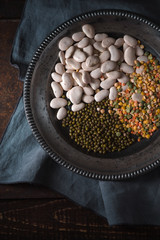 Tin plate with beans on gray napkin