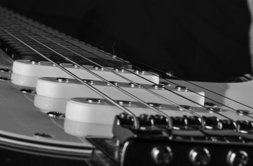 narrow cut of an electric guitar in black and white