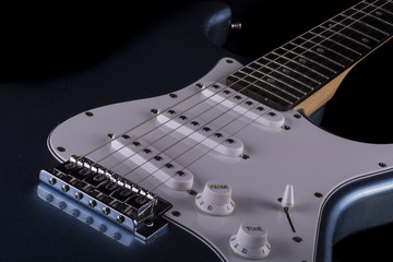 Fototapeta na wymiar narrow cut of an electric guitar in black and white