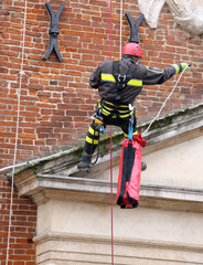 brave firefighters climbing with ropes and climbing equipment to