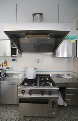 industrial kitchen with steel furniture and a aluminum pot on th