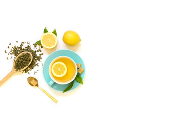 Cup of green tea with lemon and ingredients isolated on white background.